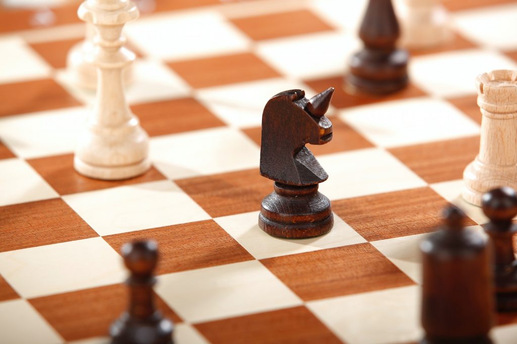 How does a Knight move in Chess